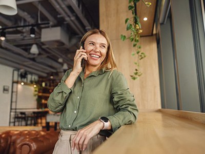 Lady schedules consultation for dental implants over phone