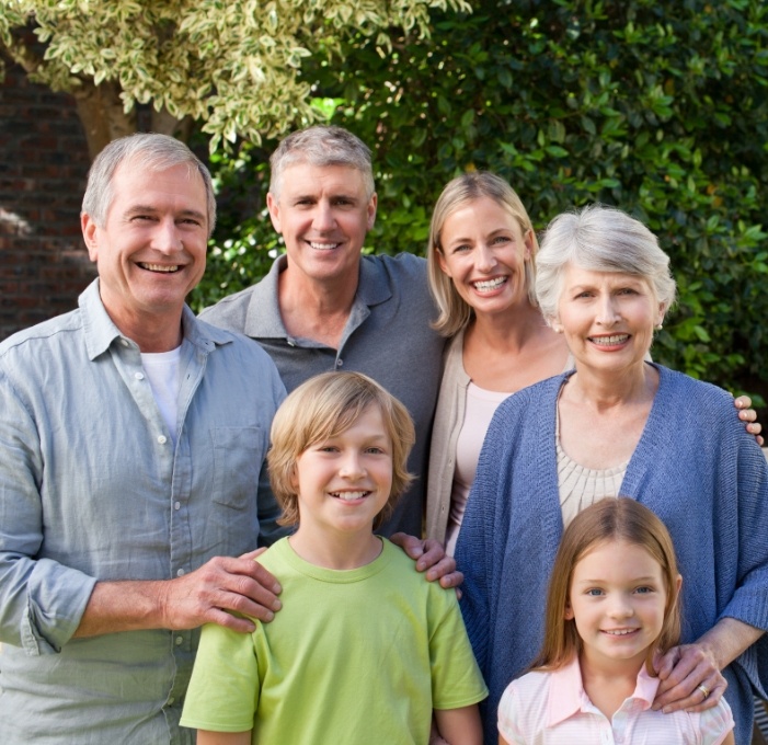 Three generations of family smiling after visiting Meadowvale dental office