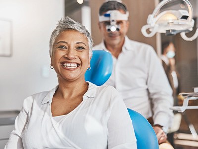 Woman smiling while sitting in dentist's treatment chair