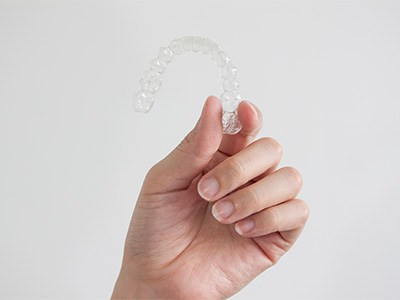 Patient holding clear aligner