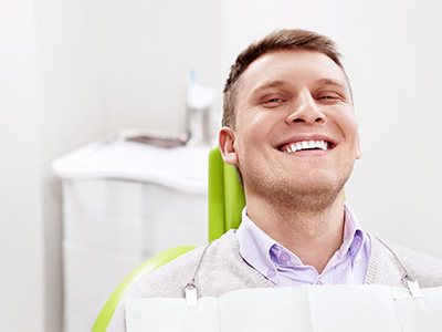 Smiling man sitting in dental office