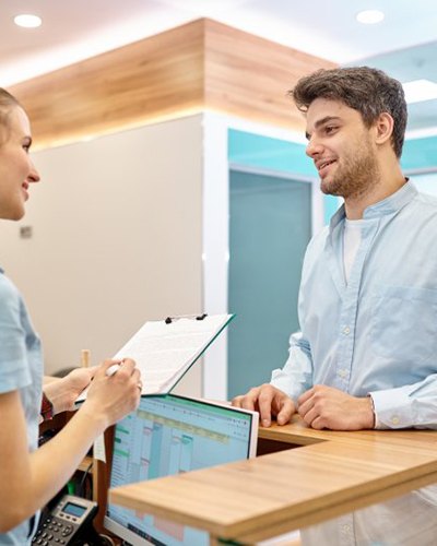 a dentist and patient giving a thumbs-up 