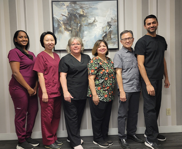 Smiling Meadowvale Family Dentistry team members standing against wall