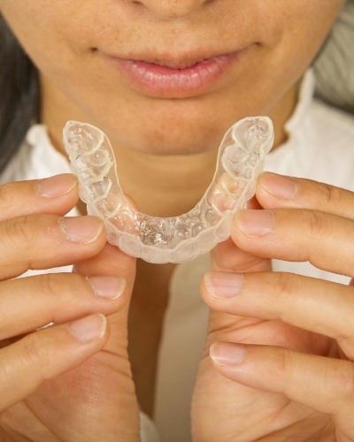 Person holding an Invisalign tray